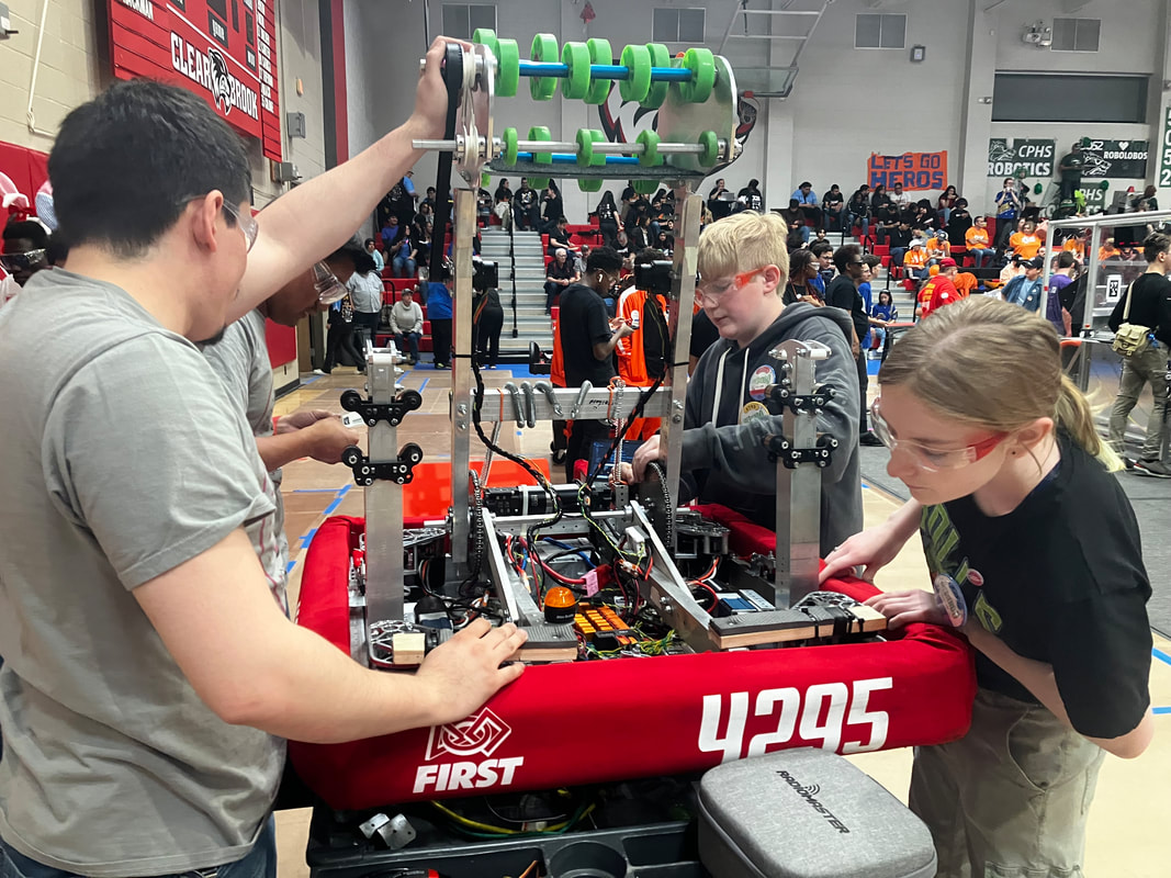 Hudson Stingers robotics team preparing robot before match